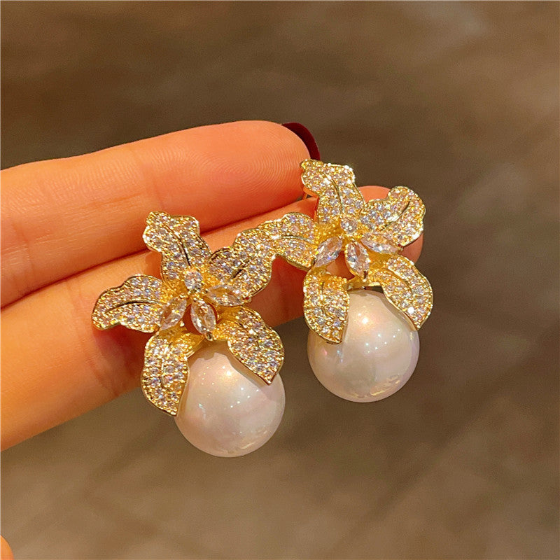 "Elegant timeless flower pearl earrings with delicate floral design and classic pearl centerpiece, perfect for weddings, bridal wear, and special occasions."