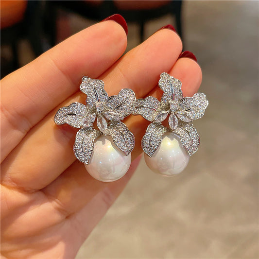 "Elegant timeless flower pearl earrings with delicate floral design and classic pearl centerpiece, perfect for weddings, bridal wear, and special occasions."